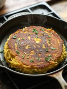 spaghetti squash pancake just after cooking in pan, looking crispy
