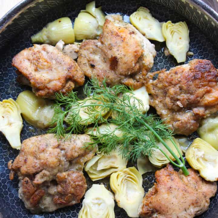overhead lemon chicken artichoke dish in skillet