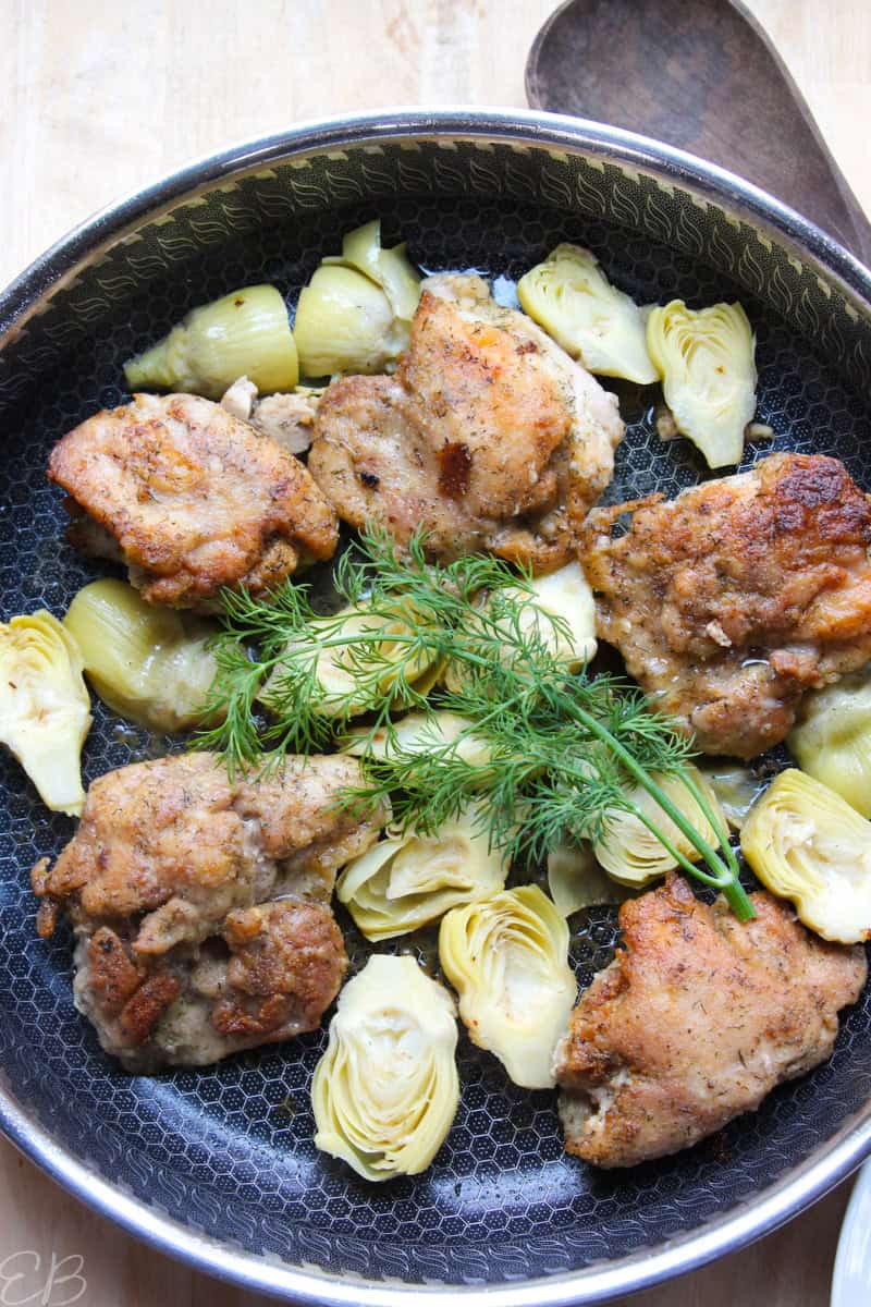 overhead lemon chicken artichoke dish in skillet