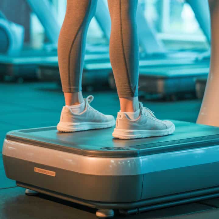 woman standing on a vibration plate