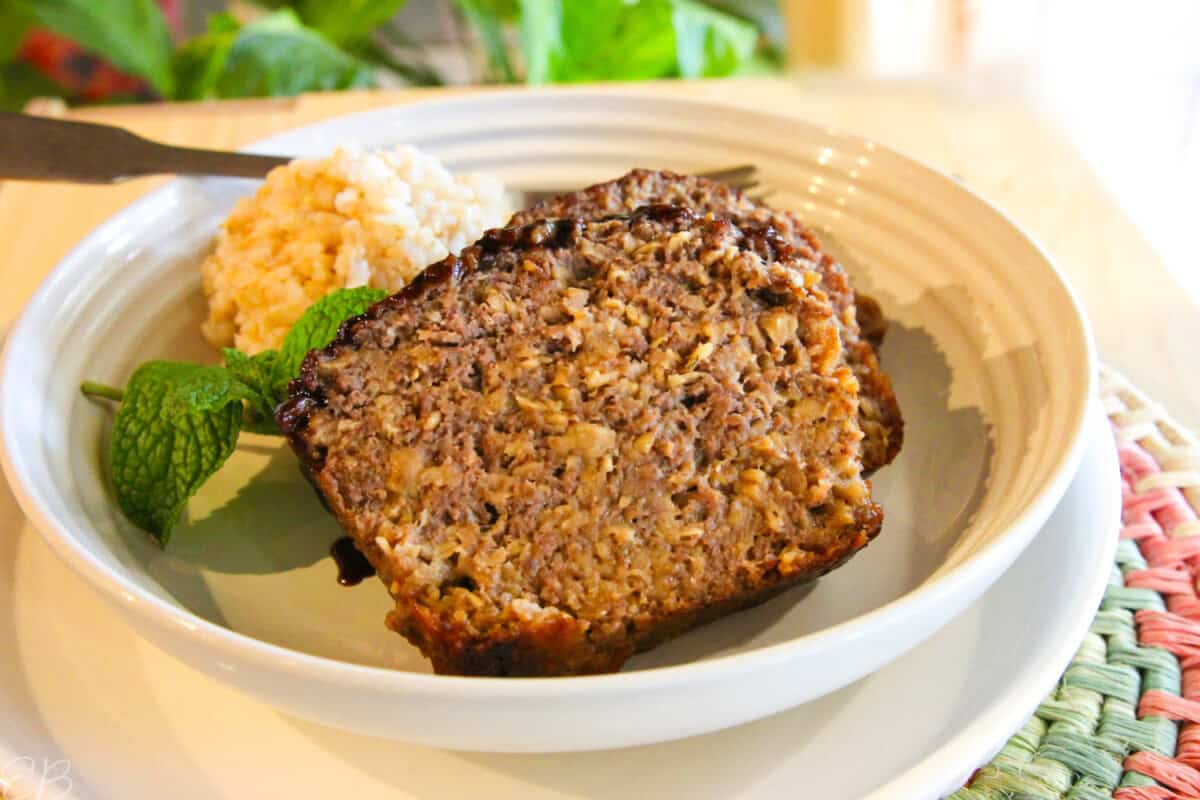 healthy meatloaf with oatmeal, sliced and served on white plate with rice