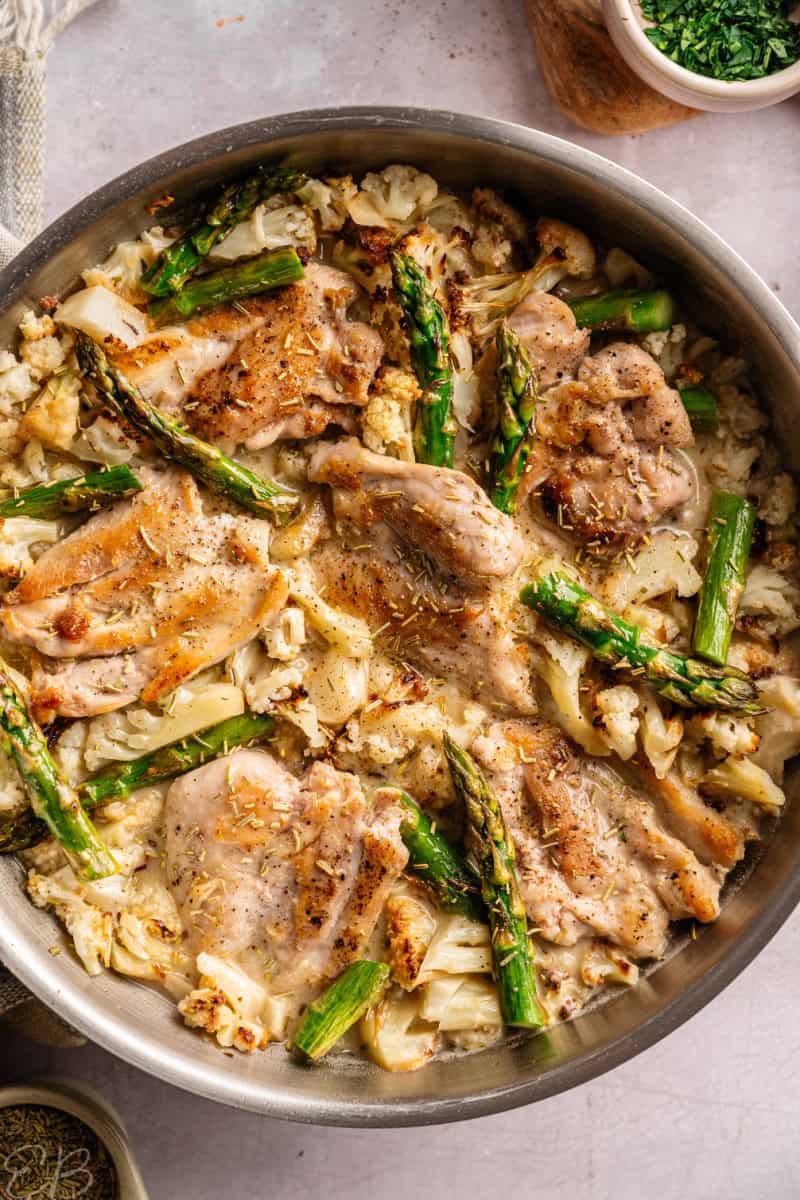 overhead view of dairy free marry me chicken with asparagus, in the pan