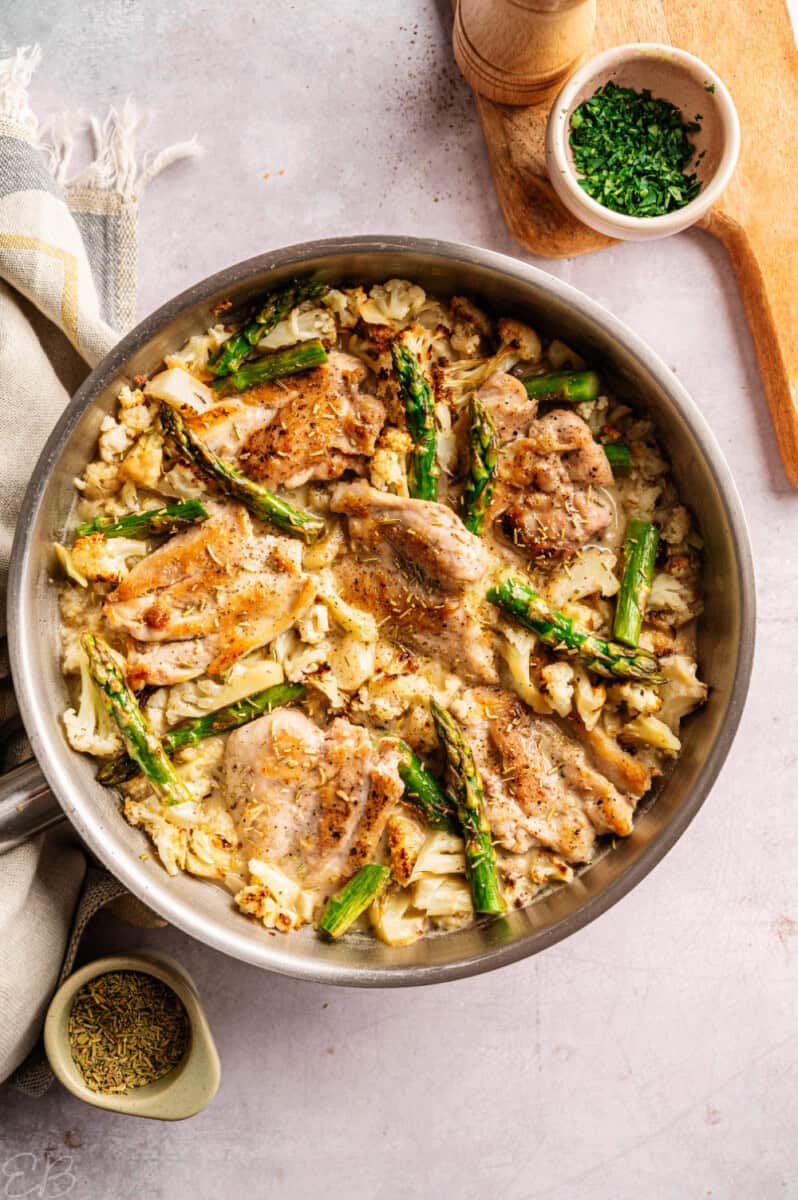 further away photo of marry me chicken with asparagus cooked in one pan