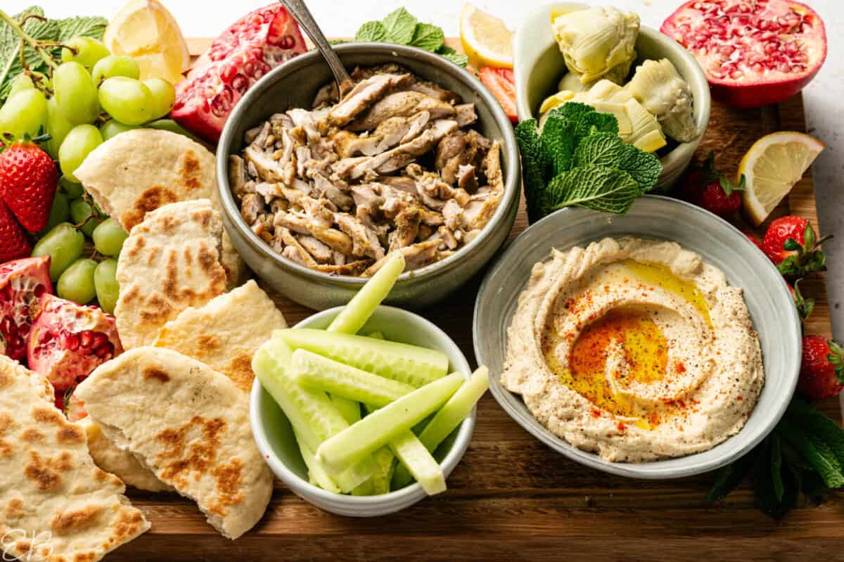 side angle view of mezza board with chicken and hummus