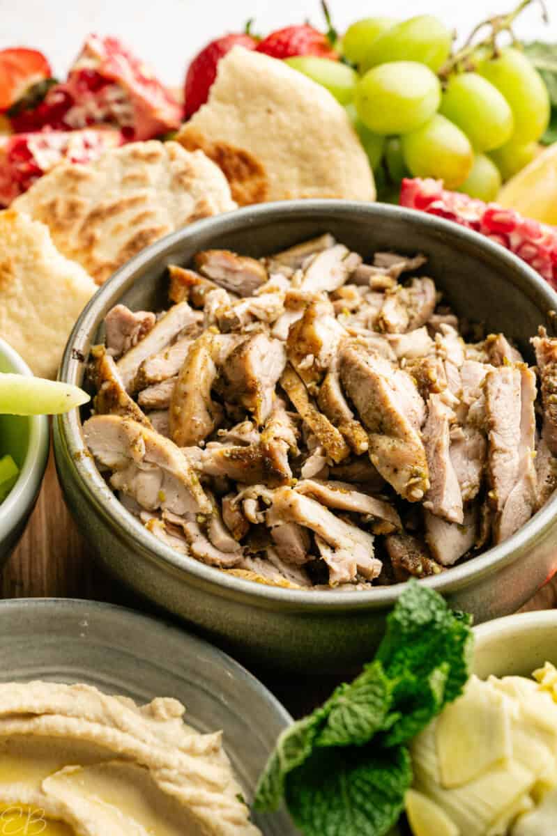 up close of za'atar chicken amidst healthy mezza