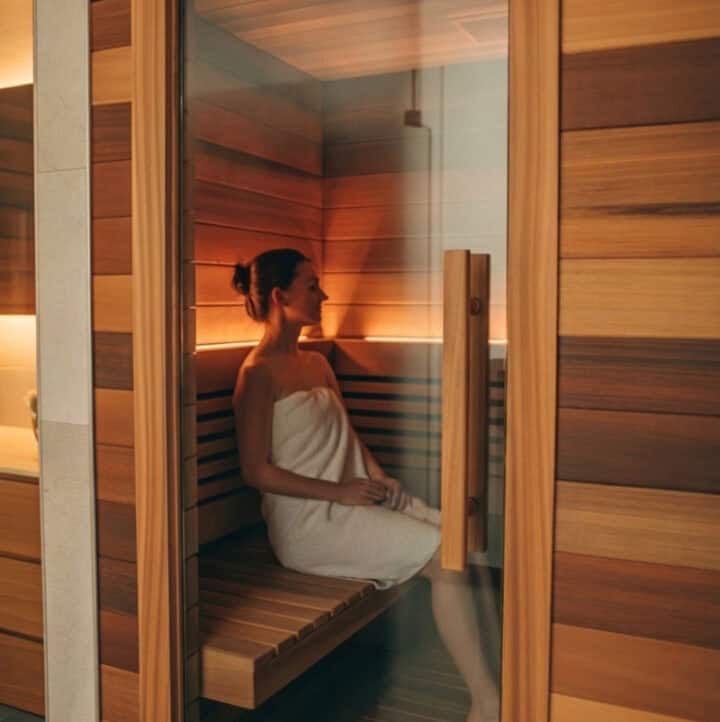 a woman using the sauna to sweat out excess copper due to copper toxicity