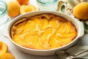 freshly baked peach cake clafouti in dish