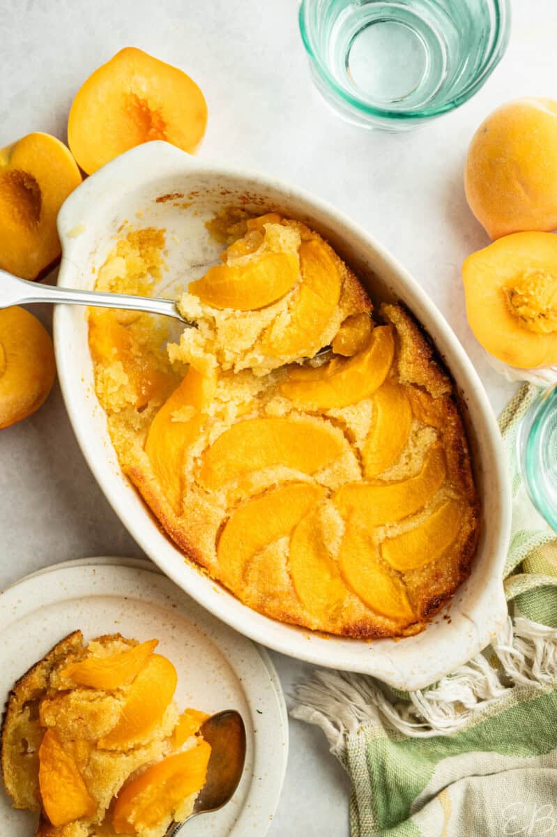 overhead view serving fresh peach cake from dish