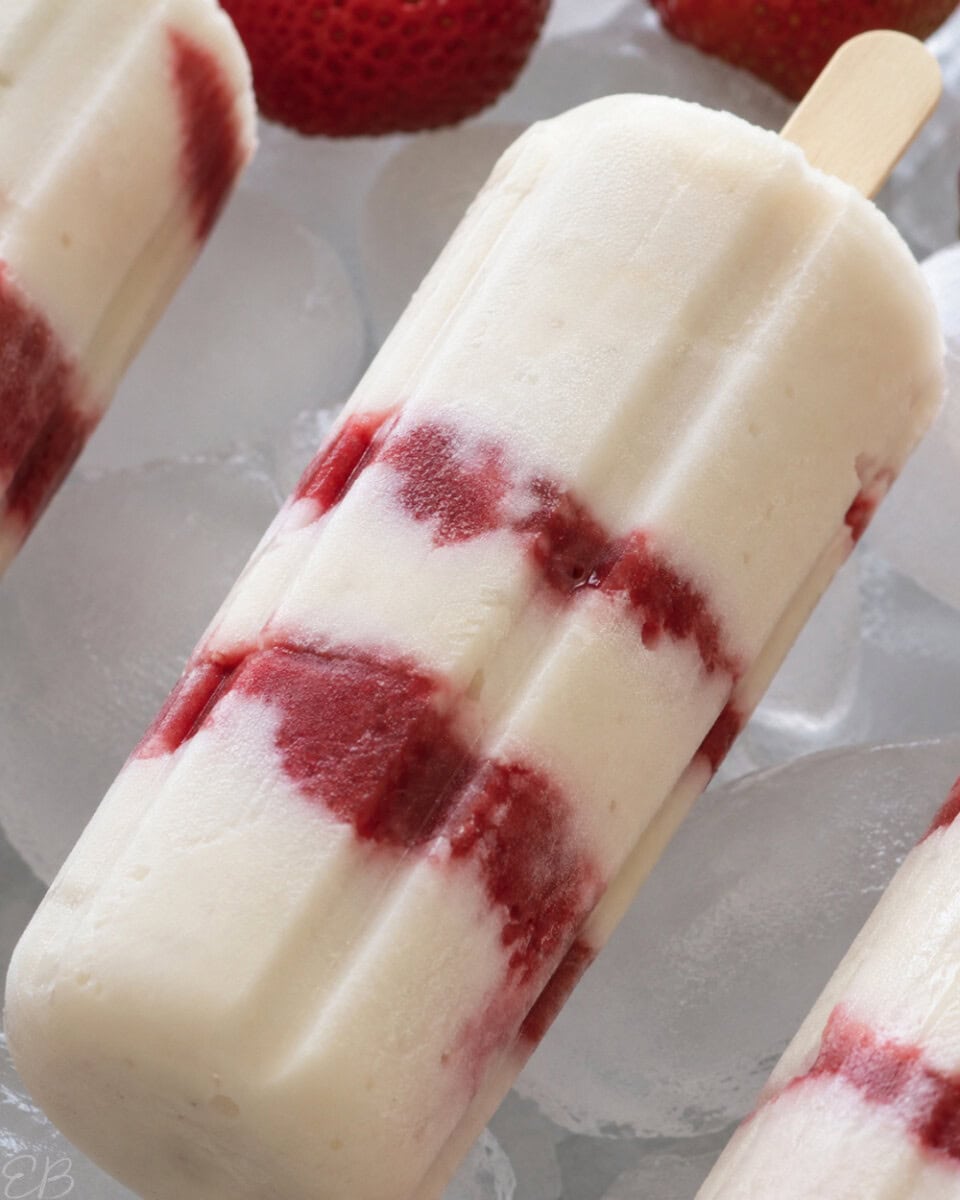 close up of vegan cheesecake popsicle on ice