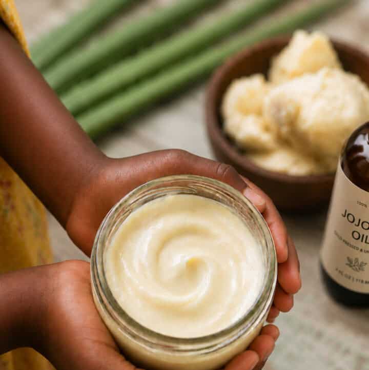 3-Ingredient DIY Hair Detangler for 4C Hair in jar held by girl's hands with ingredients in the background