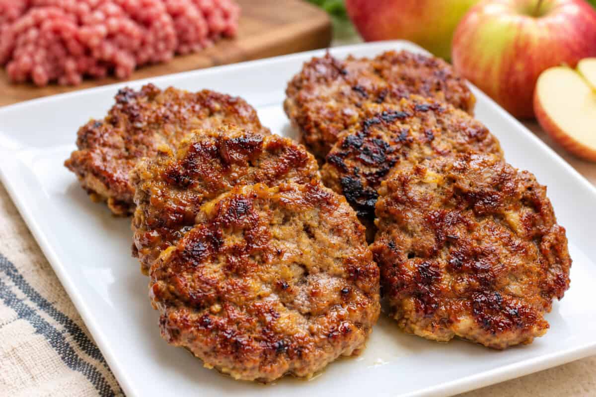 hot beef and apple sausages layered on a white plate